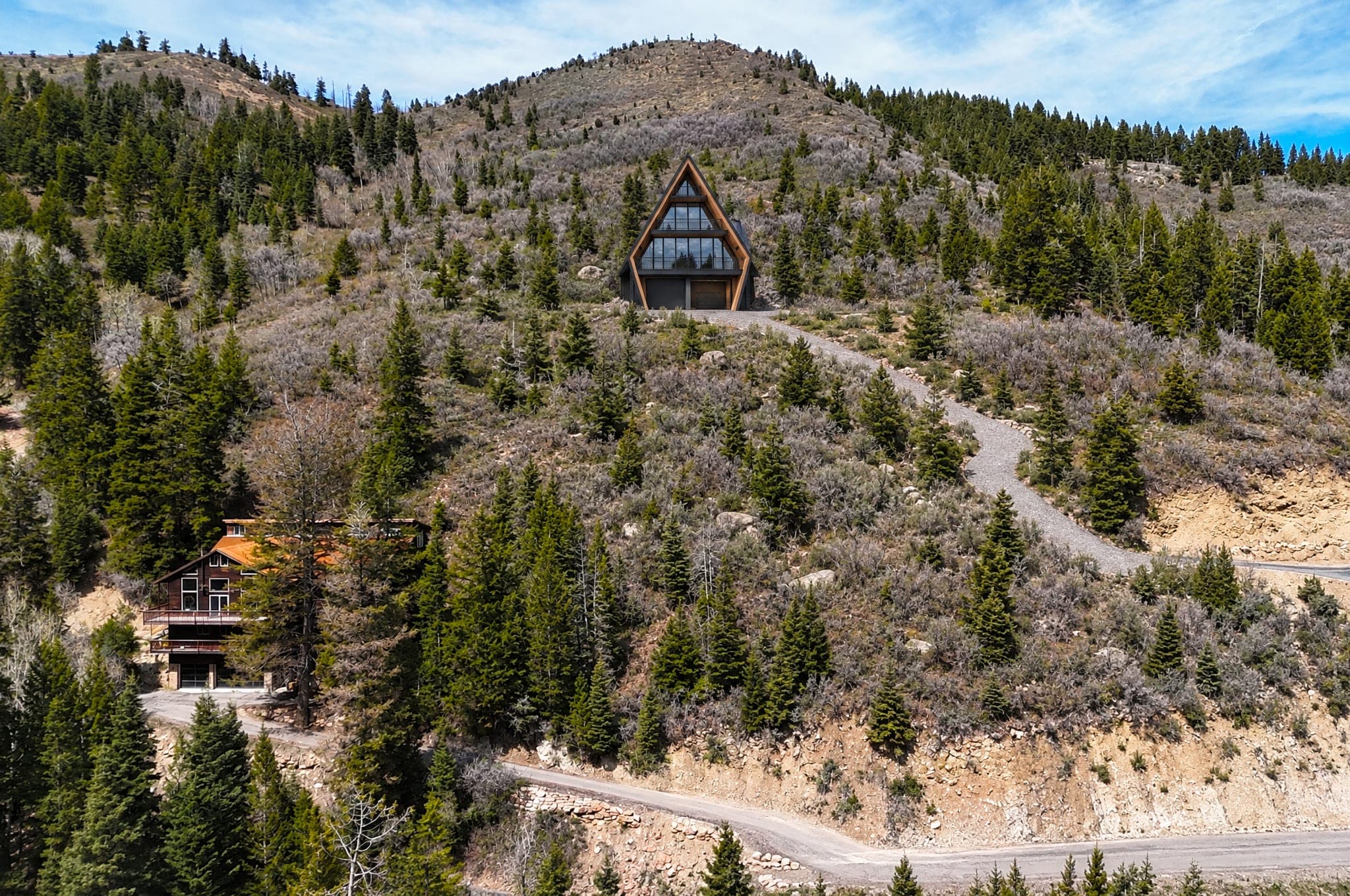 The Four seen from Matterhorn Drive in Summit Park, set well back up the sagebrush slope and reached by a long gravel driveway, the ridge rising behind